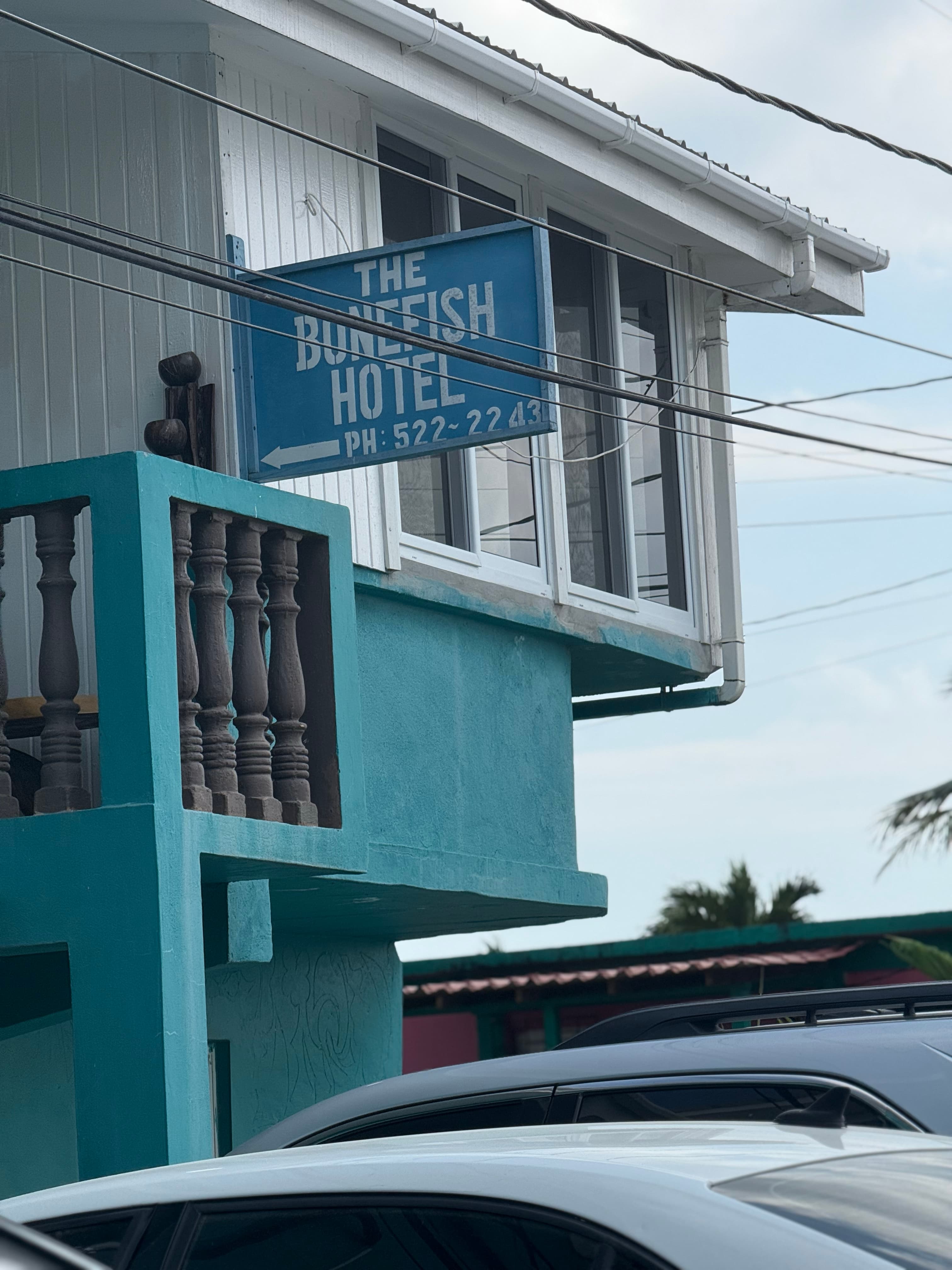 Sign for The Bonefish Hotel displayed on a building with a turquoise exterior.