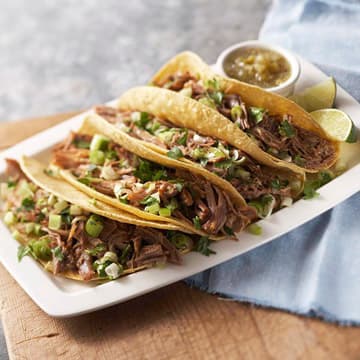 a plate of several meat tacos
